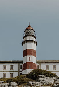white and brown lighthouse low angle photography thumbnail
