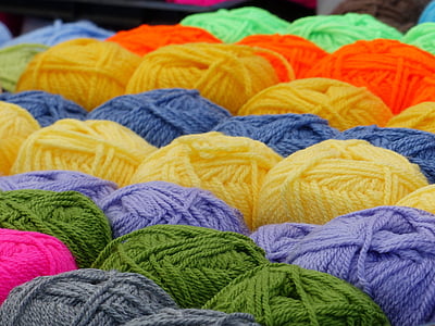 selective focus photography of assorted-color yarn thread spool thumbnail