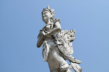 grey statue under the blue sky thumbnail