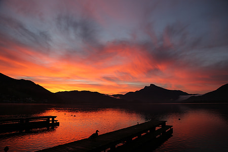 wooden dock on body of water during golden hour thumbnail