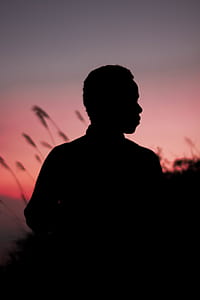 silhouette of man under orange skies thumbnail