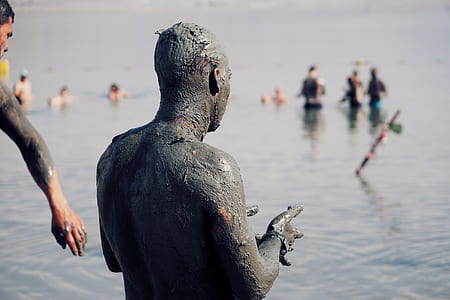 man with muds on shore during daytime thumbnail