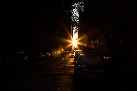 cars parked in street during sunset thumbnail