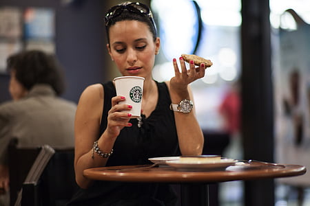 woman drinking coffee inside Starbucks shop thumbnail