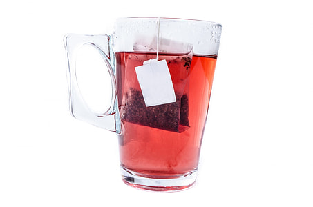clear glass cup with handled filled with red liquid thumbnail