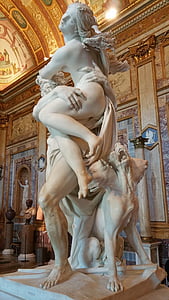 man carrying woman beside Cerberus statue thumbnail