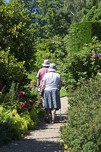 two person walking along the narrow road while wearing bucket hats thumbnail