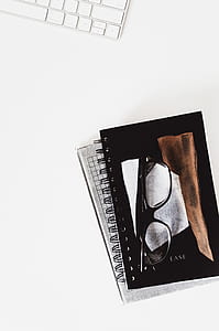 eyeglasses on black notebook thumbnail