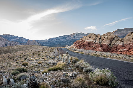 dirt road near rocks at daytime thumbnail