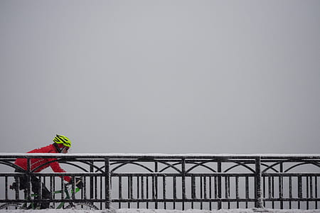 man riding on bicycle passing on black metal bridge thumbnail