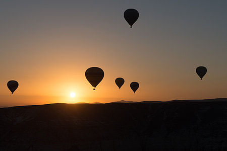 silhouette of hot air balloons floating on air during golden hour thumbnail