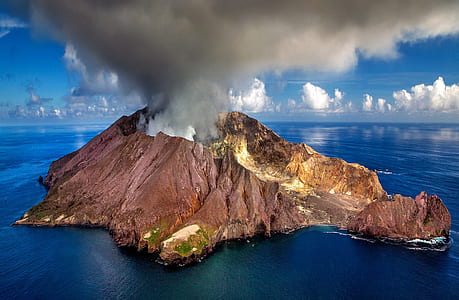 brown volcano on body of water thumbnail