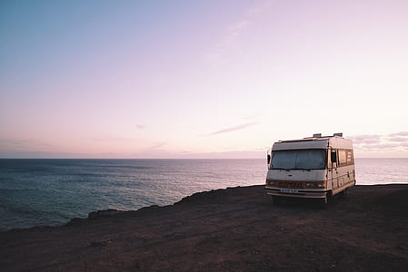 white vehicle parked on cliff thumbnail