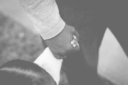 man holding baby hand thumbnail