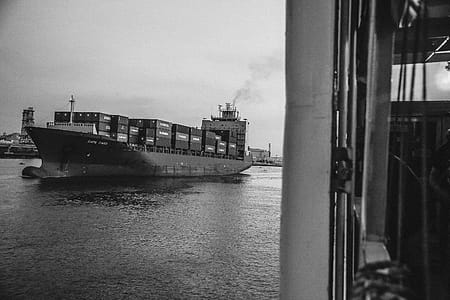 Greyscale Photo of Cargo Ship on Ocean thumbnail