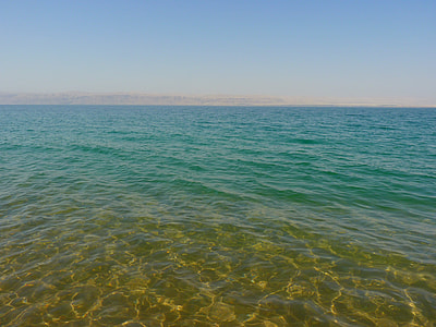 body of water under blue sky thumbnail