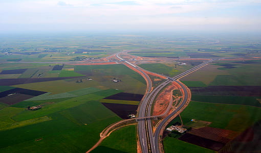 top view photo of asphalt road between grass field thumbnail