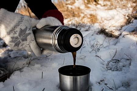 person pouring beverage on silver vacuum flask thumbnail
