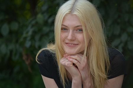 blonde haired woman wearing black shirt close-up photo thumbnail