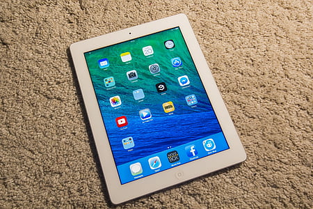 white iPad turned-on on beige textile thumbnail