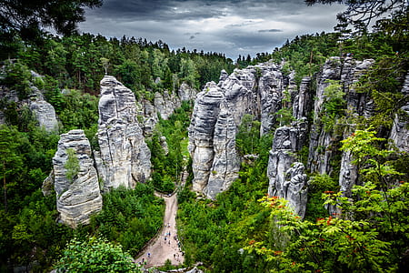 aerial photography of gray rock monoliths surrounded by trees thumbnail
