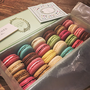 box of French macarons on top of brown surface thumbnail