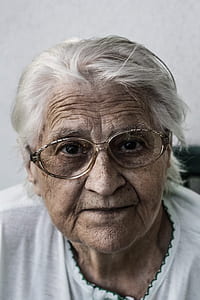 portrait of woman in white top wearing eyeglasses thumbnail