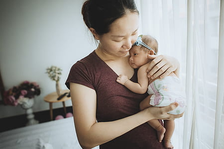 woman carrying baby thumbnail