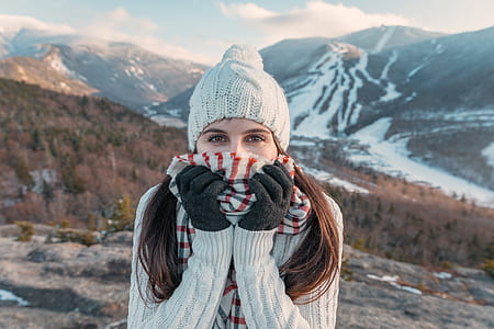 woman covering her mouth with scarf during daytime thumbnail