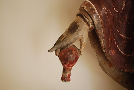 photo of person holding brown vase statue thumbnail