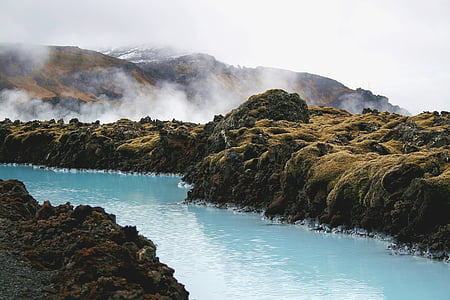 body of water in between mountains thumbnail