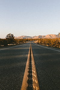 concrete road near mountain at daytime thumbnail
