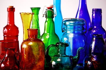 shallow focus photography of assorted-color glass bottles thumbnail