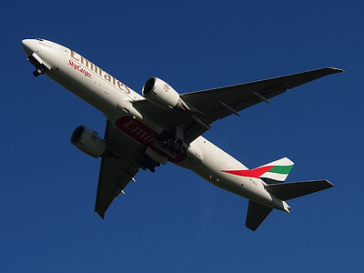 gray Emirates airliner flying during daytime thumbnail