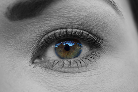 selective color focus photography of person's eye with blue retina thumbnail