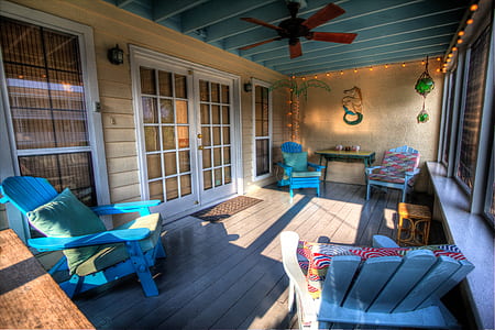 four blue wooden Adirondack chairs placed near sliding door thumbnail