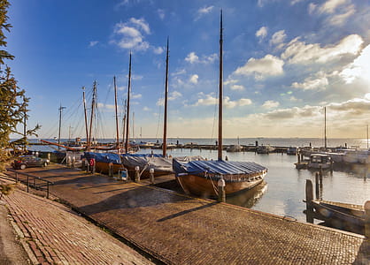 Boats Near Dock Under Gray Sky thumbnail