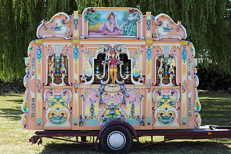 pink and teal trailer beside green trees thumbnail