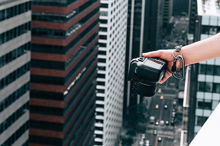 Hand With Camera Over City Photo thumbnail