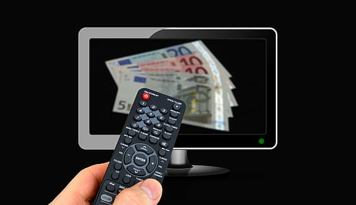person holding remote control thumbnail