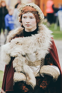 selective focus photography of woman wearing red and white fur-trimmed coat thumbnail
