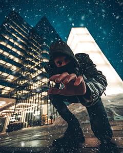 time lapse photo of man wearing hoodie surrounded by water drops thumbnail