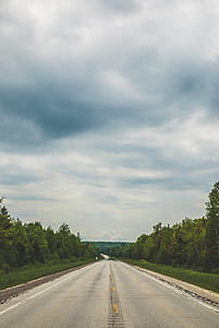 Empty Blacktop Road Under Cloudy Sky thumbnail