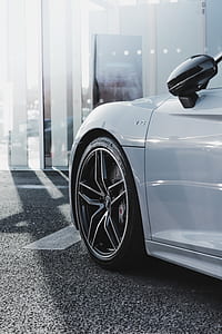white car parked on gray asphalt thumbnail