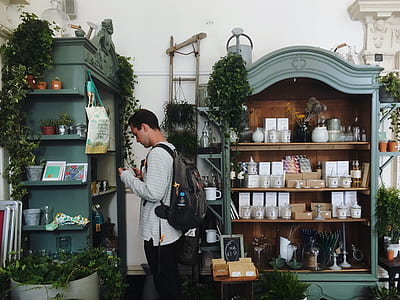 man standing in front of shelf thumbnail