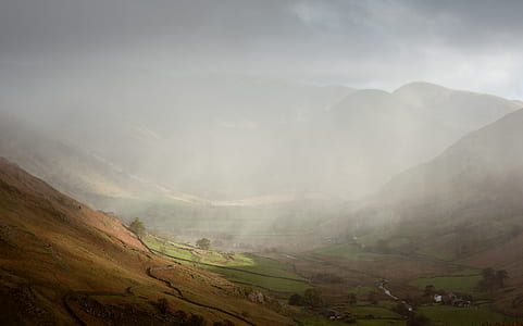brown mountains under cloudy sky thumbnail