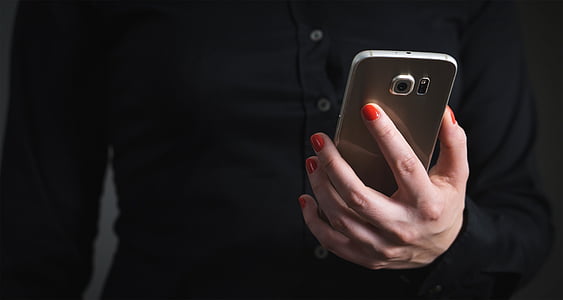 person holding gold Samsung smartphone thumbnail