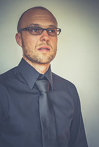 standing man in gray dress shirt thumbnail