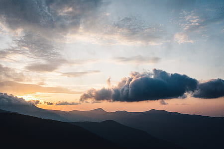 mountain ranges under white clouds thumbnail