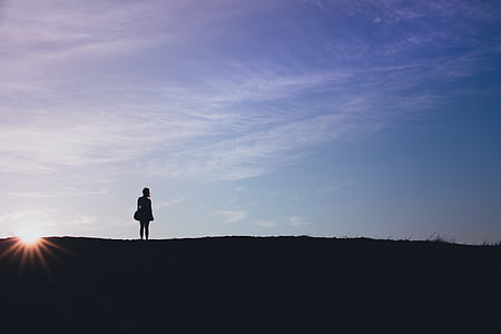 silhouette photo of woman standing mountain thumbnail